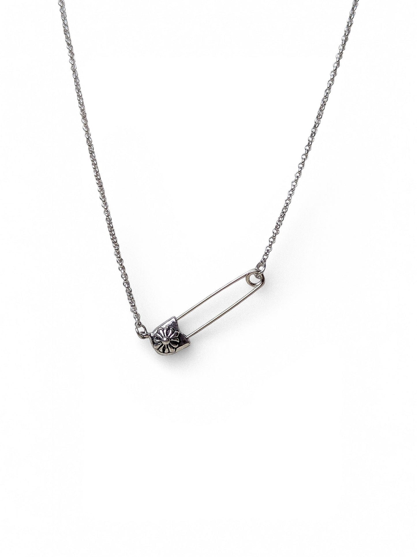 Silver safety pin pendant necklace with daisy floral charm on dual stainless steel layered chains